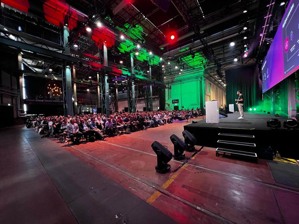 Emanuel presenting at AWS Summit to large audience